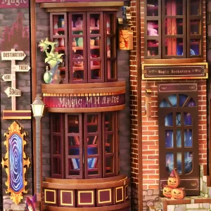 A close-up of the wizard shops in the Magic Alley DIY Book Nook, featuring detailed storefronts, glowing signs, and a magical portal.