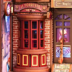 A detailed close-up of a wizard shop in the DIY book nook, showing a bay window, a vintage sign, and warm glowing lamps inside.