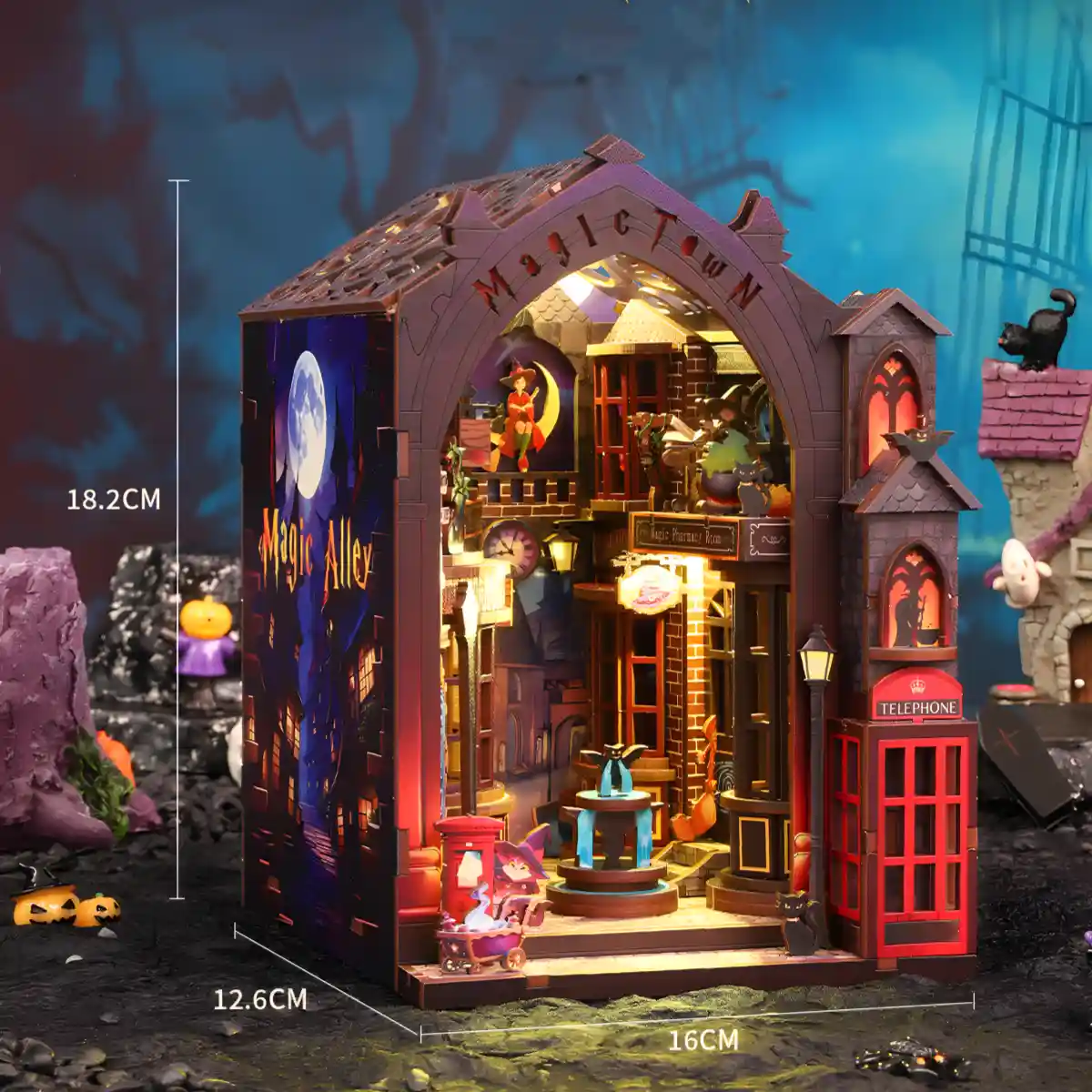 The dimensions of the Magic Alley book nook are displayed on an image of the glowing fantasy world kit, showing its size for a bookshelf.