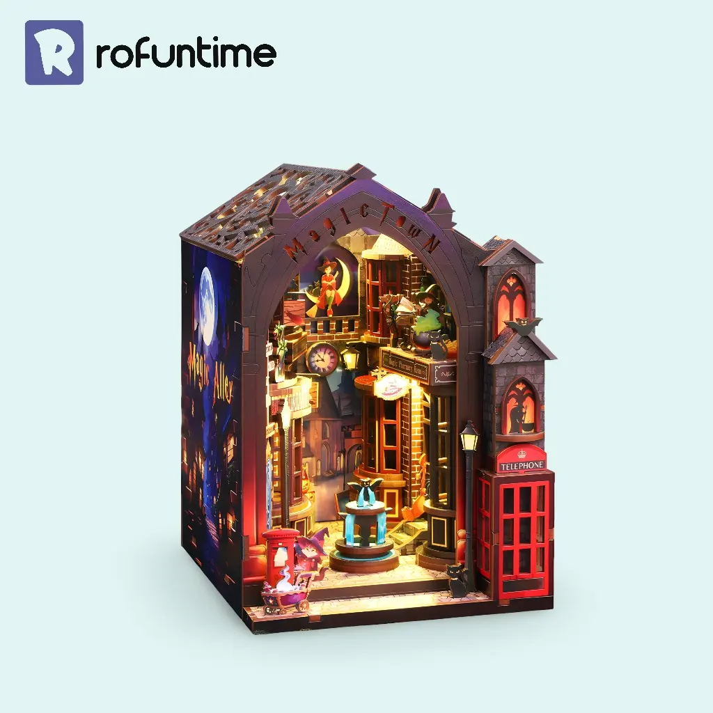 Assembled Magic Alley book nook kit glowing with lights, featuring detailed wizard shops and a secret alley for a fantasy world bookshelf insert.