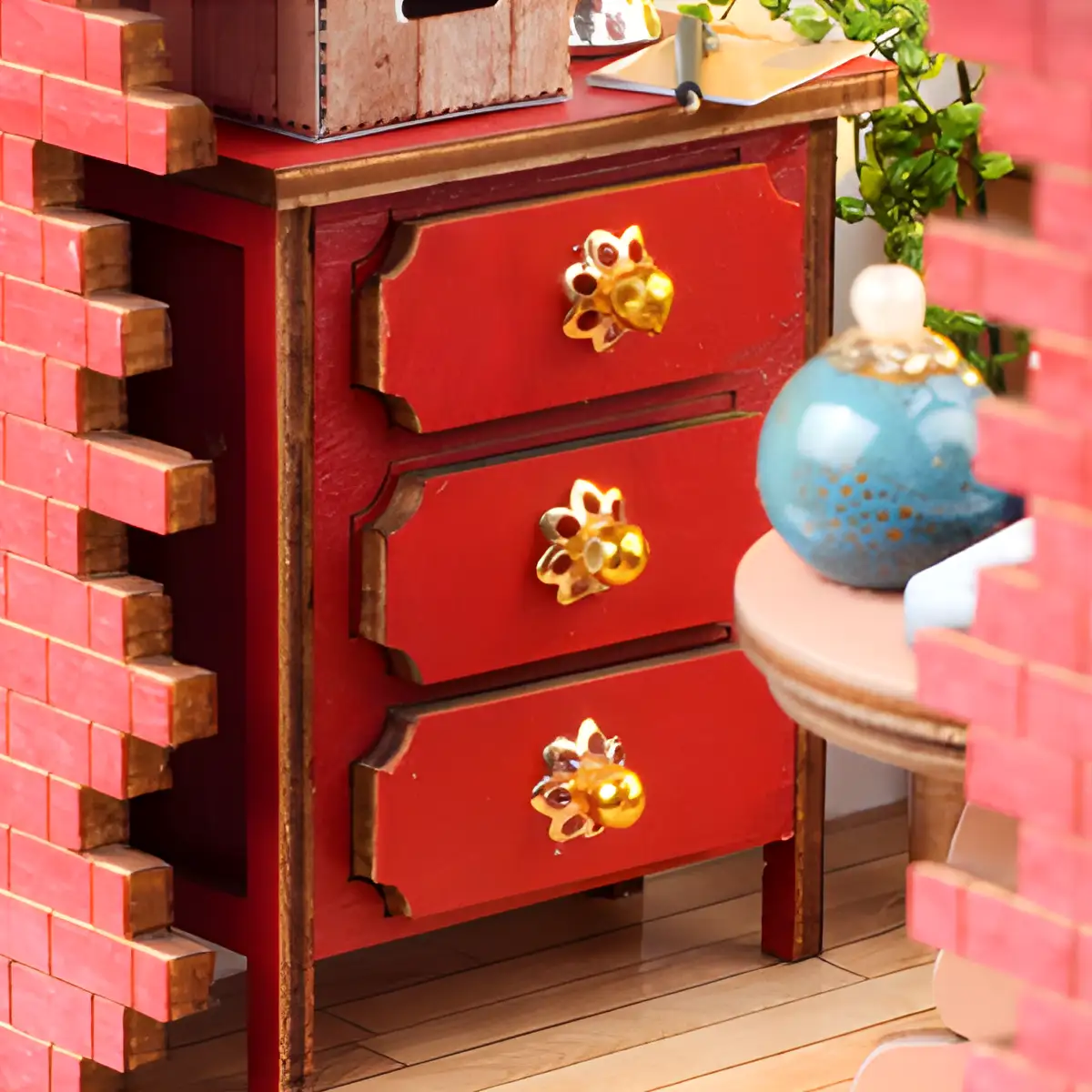 Magic Shack Miniature House, red cabinet with golden handles, detail close-up.