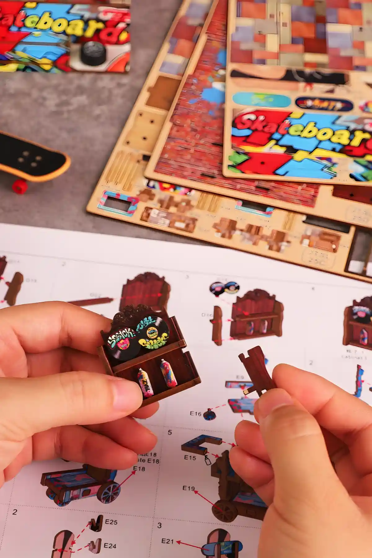 Hands assembling the Book Nook Kit, connecting Graffiti shelf components, following instructions.