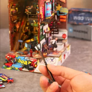 Hand holding miniature street lamp for the Skate Competition DIY Book Nook Kit.