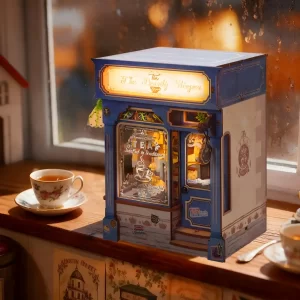 Cozy corner scene featuring The Dainty Steeper book nook on a rainy windowsill with a teacup.