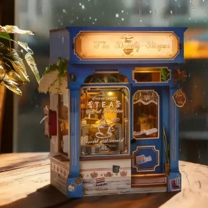 The Dainty Steeper book nook glowing on a table, a cozy British lifestyle miniature scene.