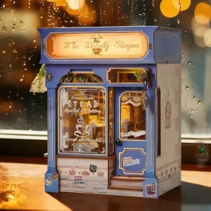 The Dainty Steeper DIY Book Nook Kit, illuminated English vintage tea shop, rainy window.