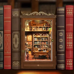 The Book House book nook displayed between books, a perfect book lovers gift and unique bookshelf décor.