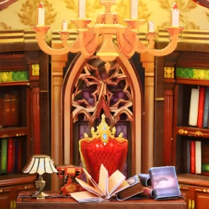 A grand miniature chandelier and regal chair in the World Bookstore book nook, a cozy warm light miniature scene.