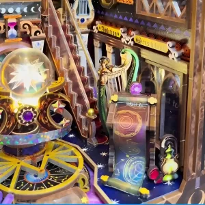 Close-up on the Zodiac Fantasy book nook's zodiac scroll, harpist figure, and glowing crystal sphere; a detailed crystal sphere book nook.