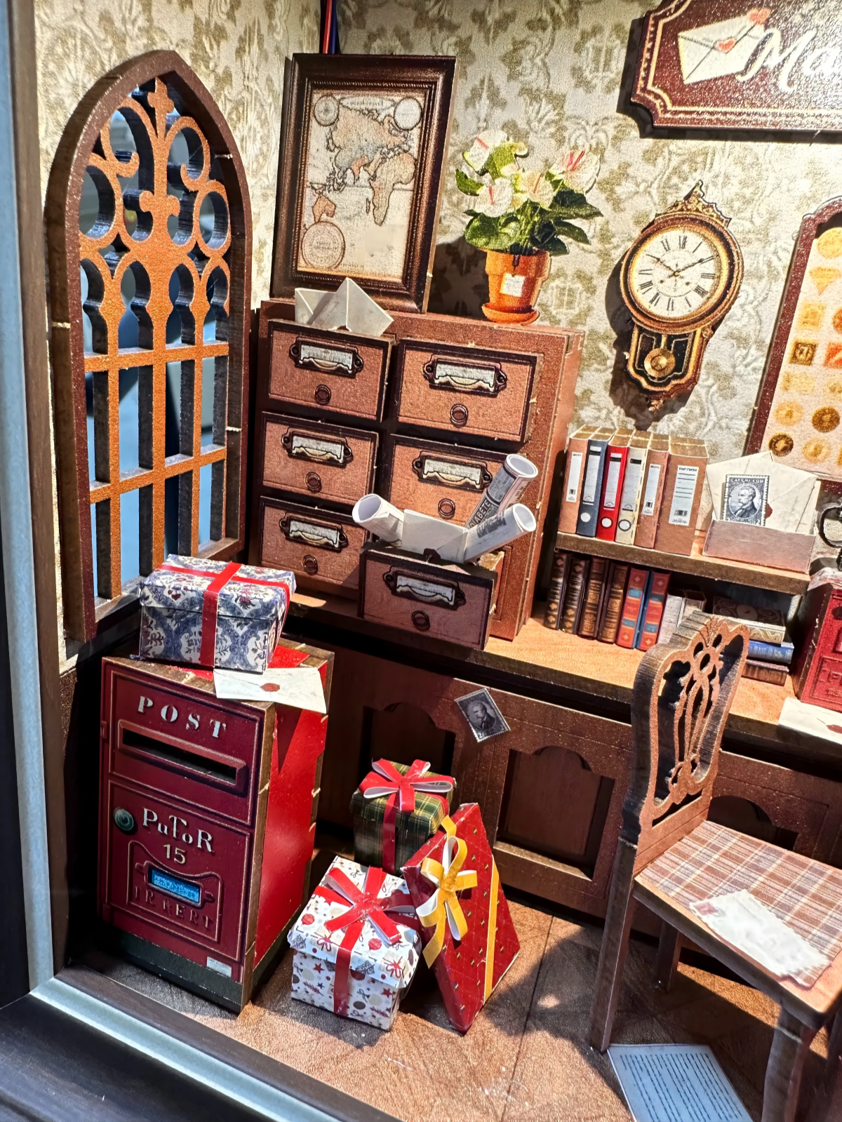 Close-up of Mail Gift Cottage book nook vintage storage cabinet and red post box.