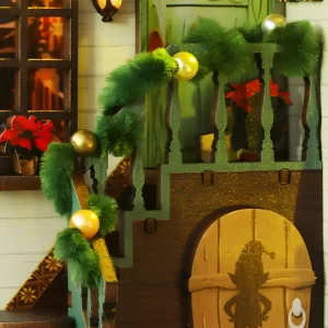 Elegant staircase detail in DIY Book Nook with green garland and gold ornaments.