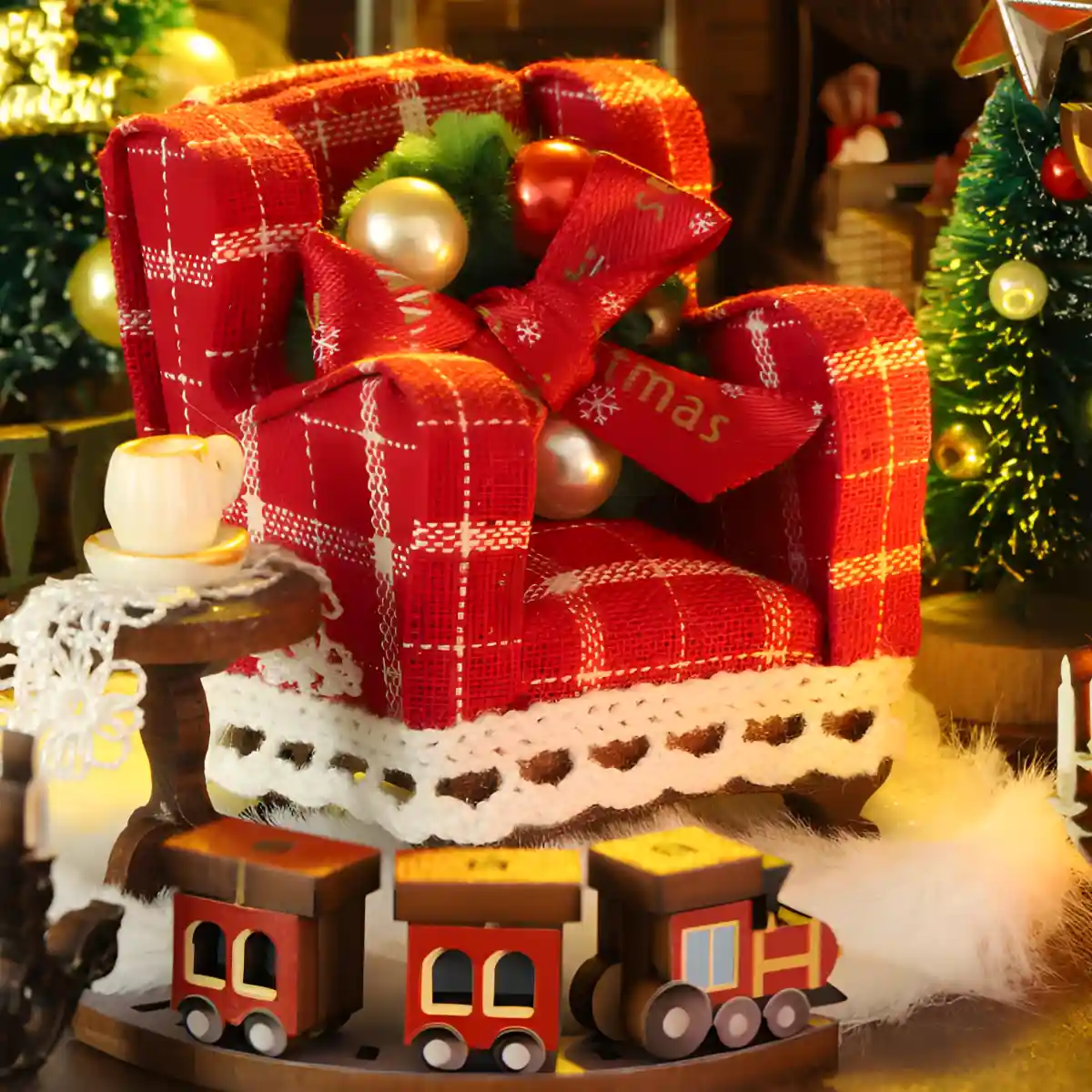 Red plaid armchair and tiny train set in Merry Christmas book nook interior.