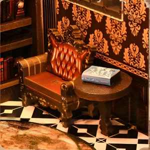 Miniature European single sofa, table, and book detail inside the Wisdom Rings Bookstore book nook.