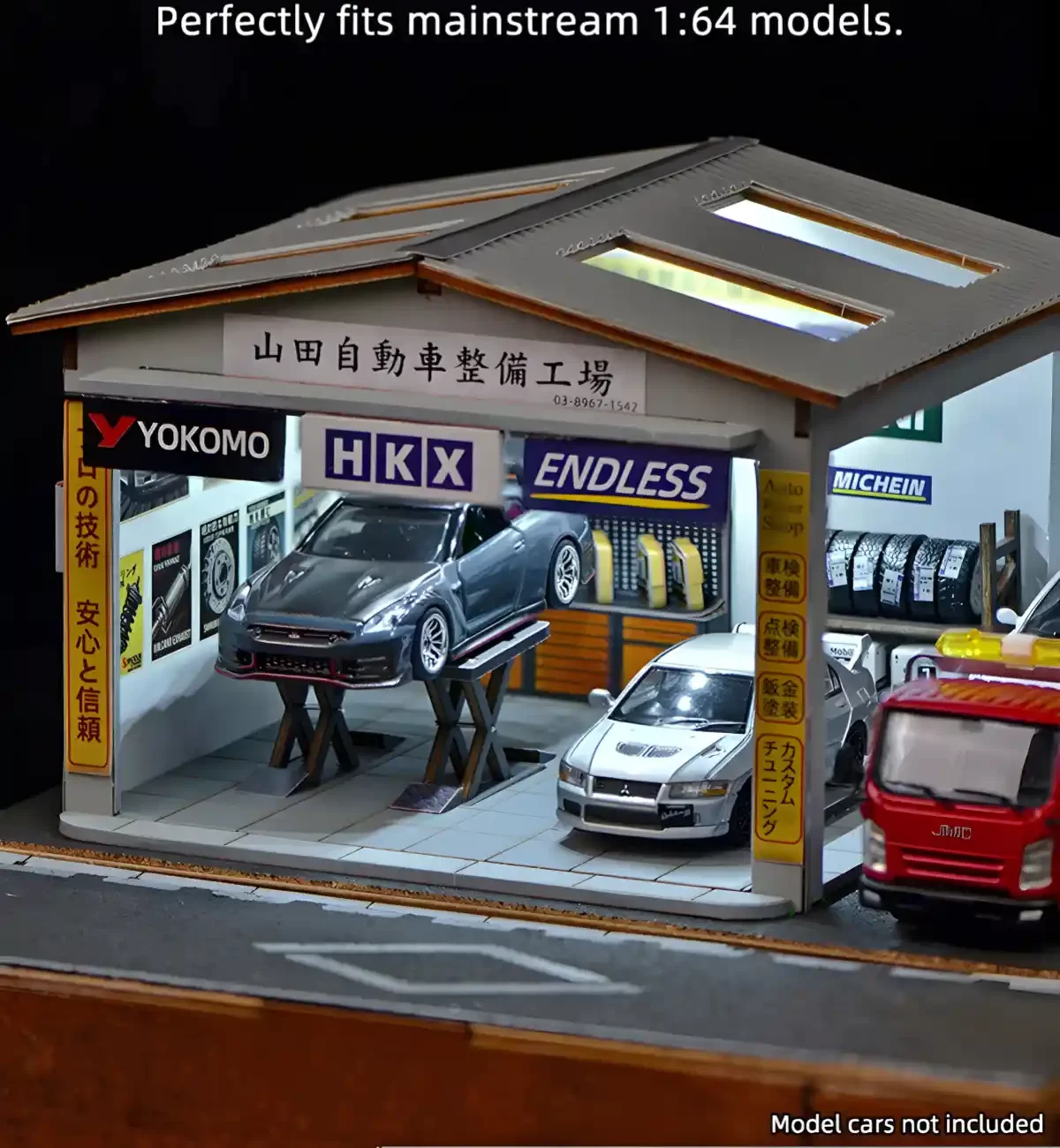 1:64 Diorama of Yamada Auto Repair Shop with JDM cars on the lift and floor.