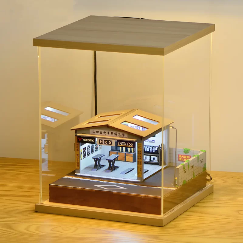 Yamada Auto Repair Garage Miniature House inside dust cover, fully illuminated, front view.