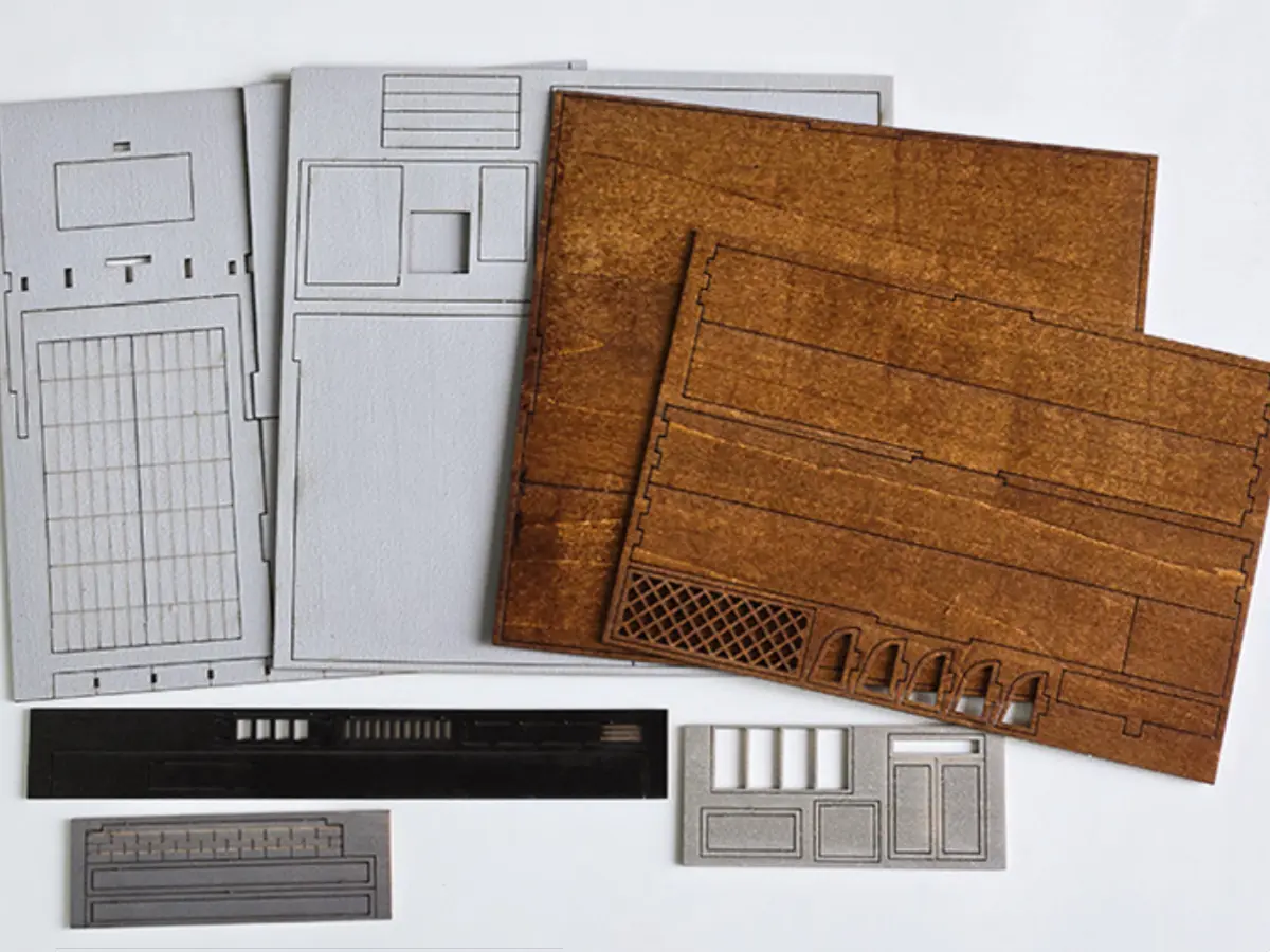 Pre-cut wooden pieces for Yamada Auto Repair Garage DIY Miniature House Kit assembly.
