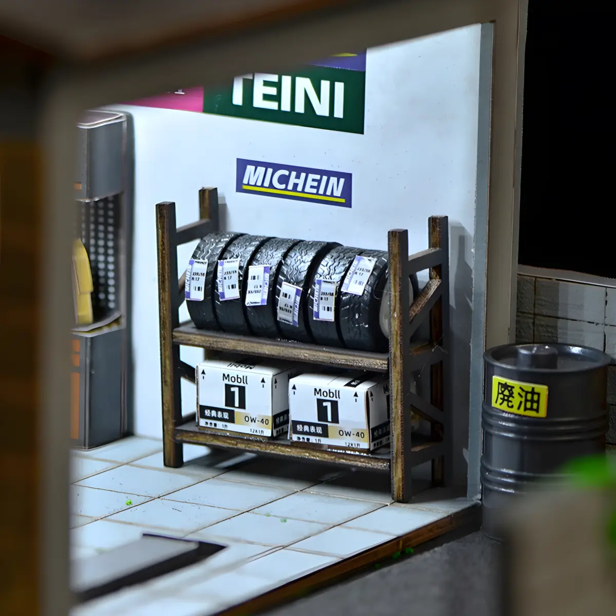 Interior detail of Yamada Car Workshop Miniature Kit with tire rack, oil cans, and sponsor logos.