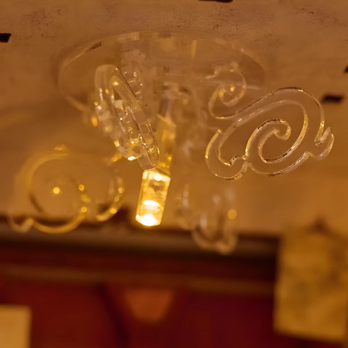 Intricate cloud-shaped chandelier inside the Art Bookstore DIY Book Nook Kit, featuring warm LED lighting.
