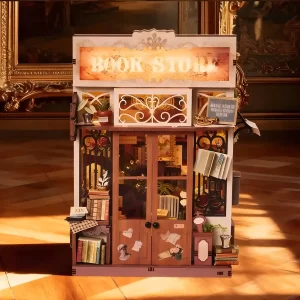 Full front view of the lit Art Bookstore DIY Book Nook Kit doors and sign in a gallery setting.