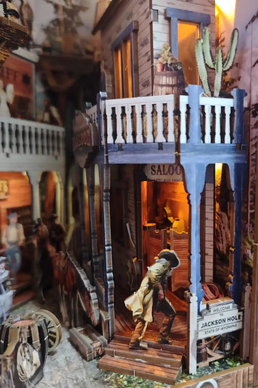 Vintage Western book nook Saloon entrance with Jackson Hole Wyoming sign and cactus detail.