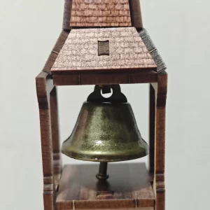 Close-up of brass bell in a rustic wooden tower, Western Town Book Nook Kit detail.
