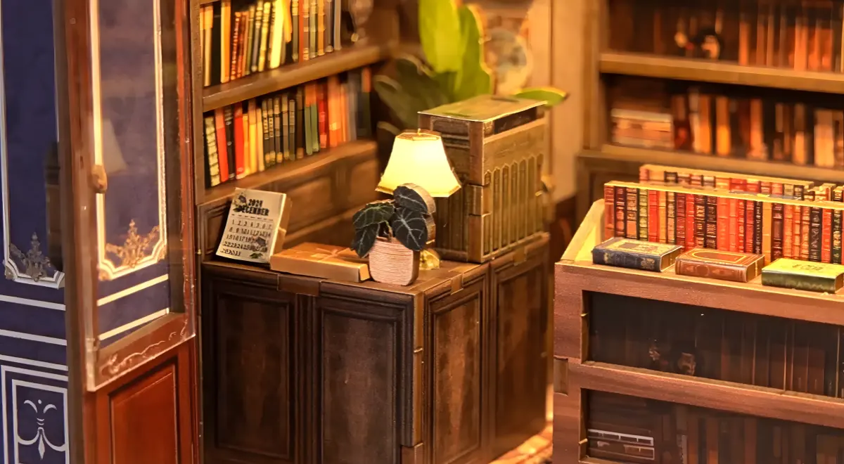 Close-up of bookstore counter in Notting Hill Stories DIY miniature house, slow living crafts detail.