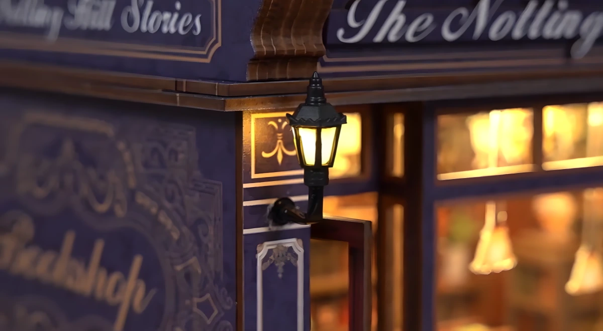 Detail shot of glowing front light on Notting Hill Stories DIY miniature house exterior facade.