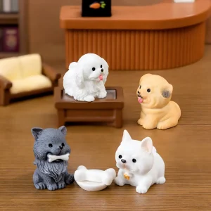 Four resin dog miniatures including a maltese and bulldog with a tiny bone accessory