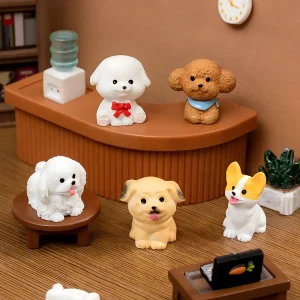 Collection of five mini dog figurines including poodle and corgi in a miniature office
