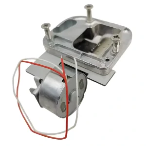 Underside of battery powered music box mechanism showing mounting screws and motor housing