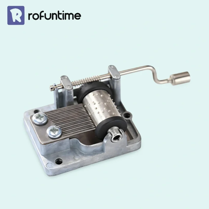 Silver hand crank music box mechanism, 18 note mechanical movement for DIY crafts and music boxes.