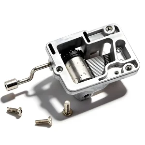 Underside of a hand crank music box mechanism with gears, including mounting screws for craft installation.