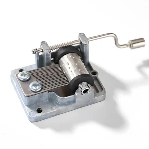 Close-up of portable music box mechanism, featuring the pinned cylinder and steel comb for 18-note melody.