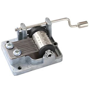 Compact mechanical music box movement, hand crank operated, ideal for small handmade musical gifts.