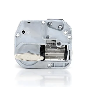Rear view of an 18 note music box mechanism showing mounting holes and winding key assembly.