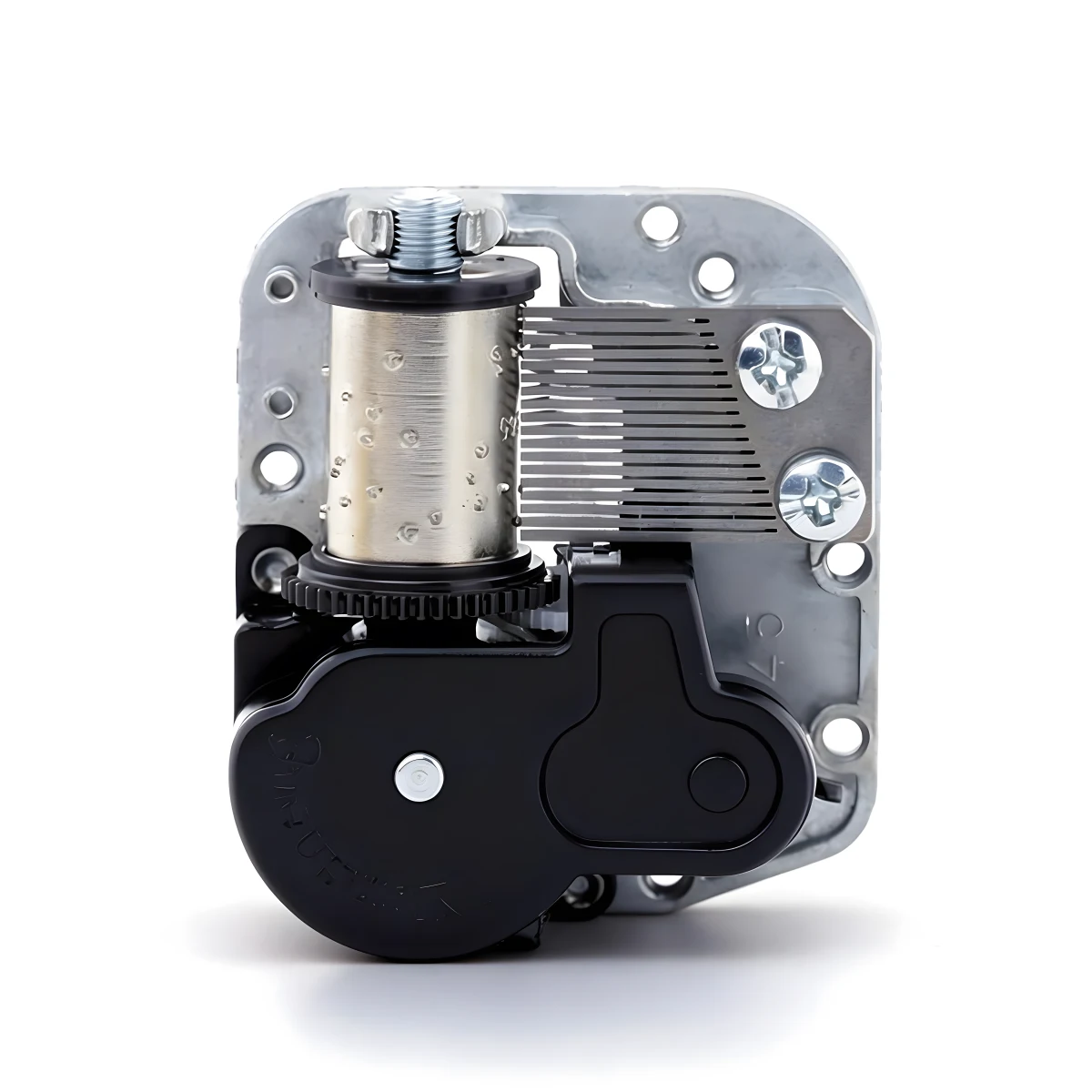 Top-down view of a mechanical music box mechanism with black gear housing and silver cylinder.