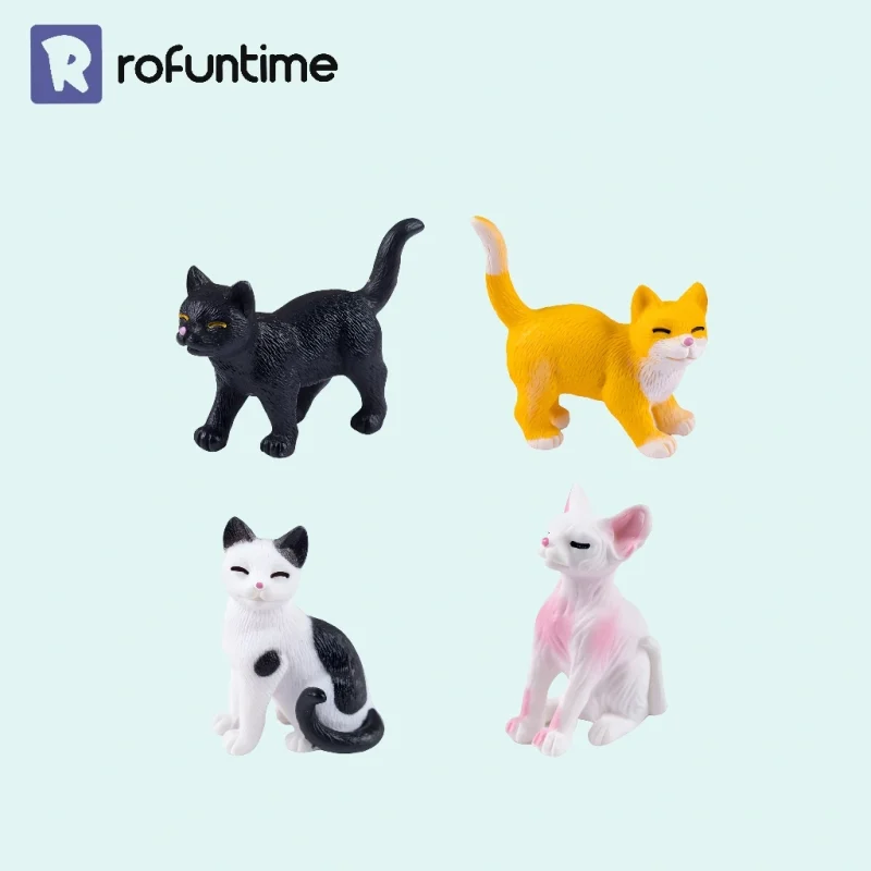 Four miniature cat figurines set with black, ginger, tuxedo, and sphinx cat figures.