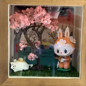 Pink miniature flower powder for book nook tree in a Japanese-style shadow box frame