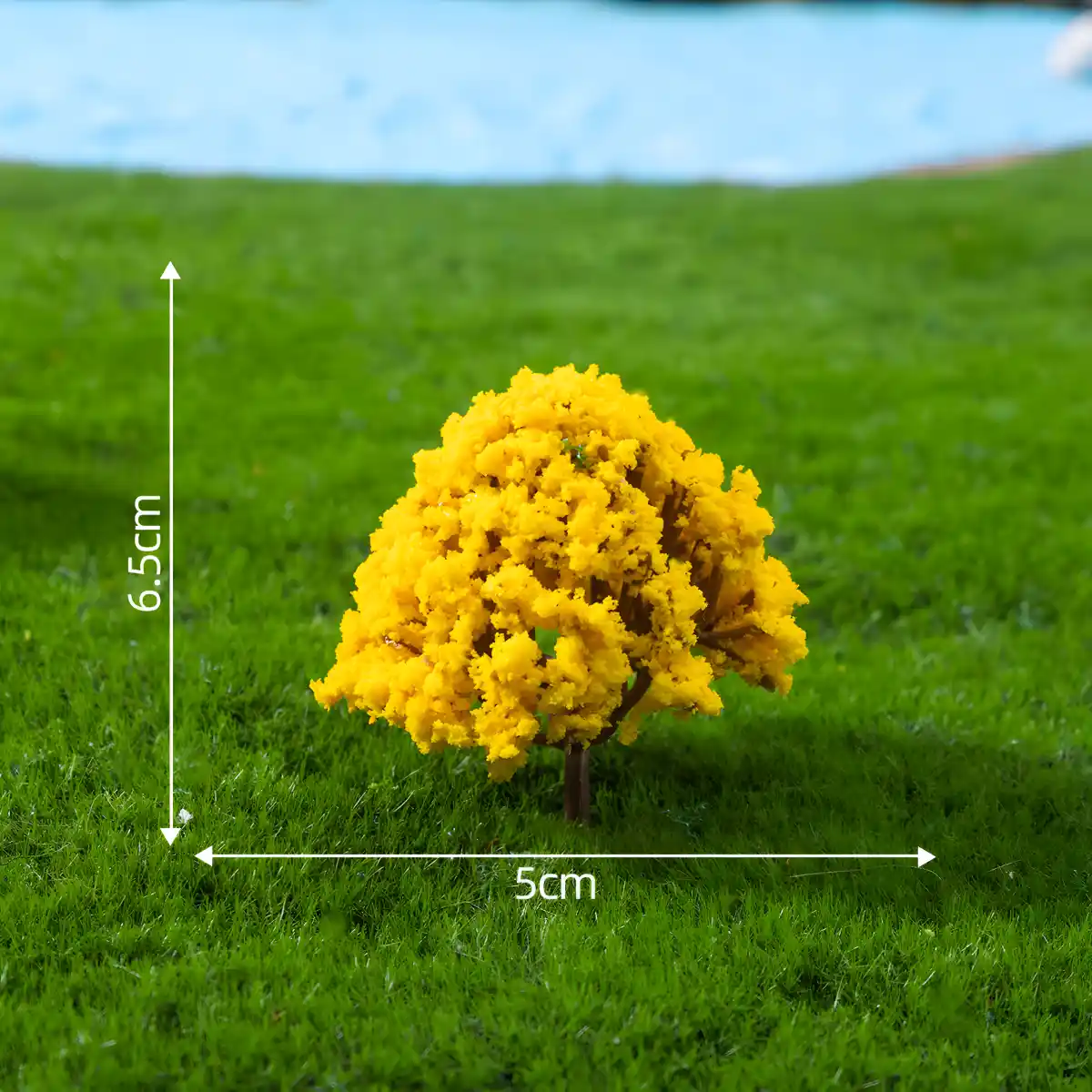 Bright yellow miniature flower trees providing a pop of color for seasonal dollhouse landscape designs.