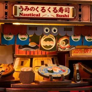 Miniature Japanese restaurant with light featuring a DIY rotating sushi bar model and tiny food plates.