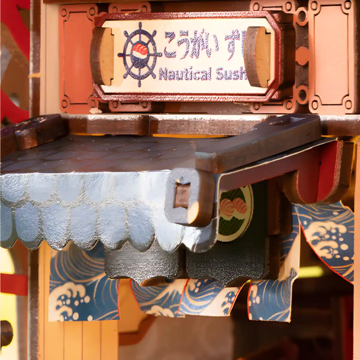 Japanese sushi boat model kit featuring laser-cut decorative wooden waves and blue-toned mechanical components.