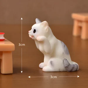 Gray and white resin cat miniatures sitting for book nook miniature animals table scene.