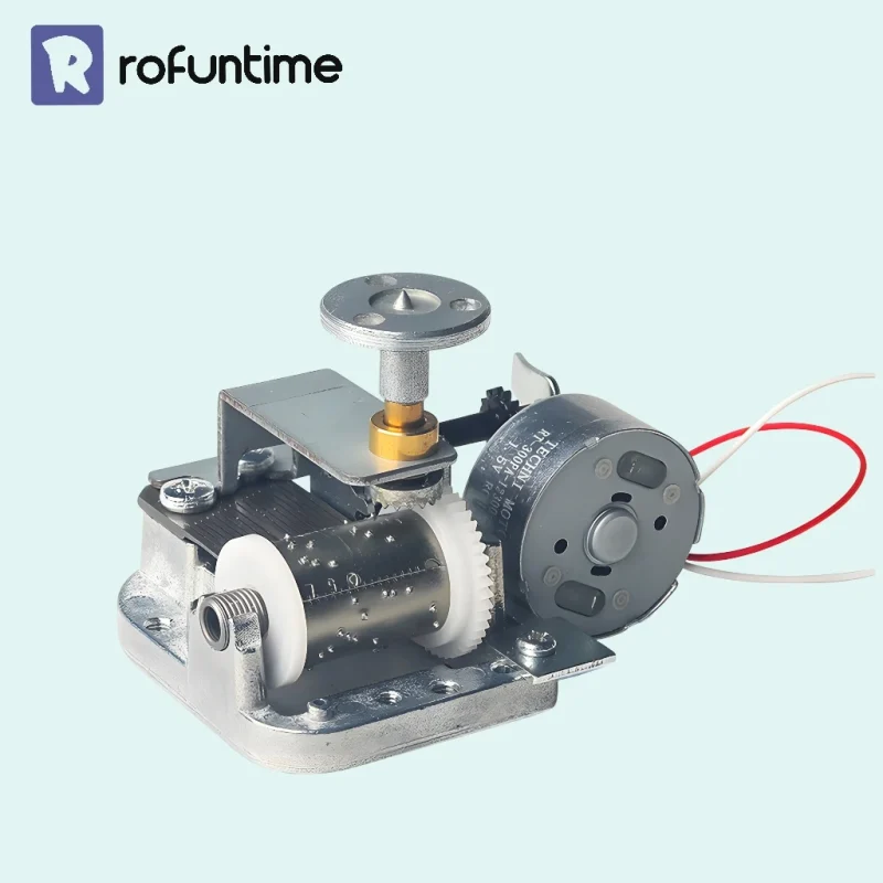 Front view of a rotating music box mechanism with 18 note comb and electric motor.