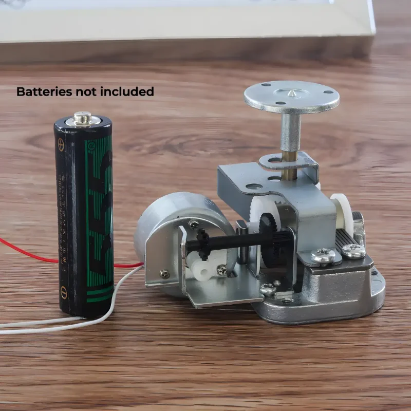 Compact 18 note music box mechanism size comparison with a standard AA battery.