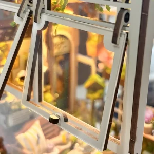 Close-up of functional opening wooden windows on the Sylvia Garden Book Nook Kit.