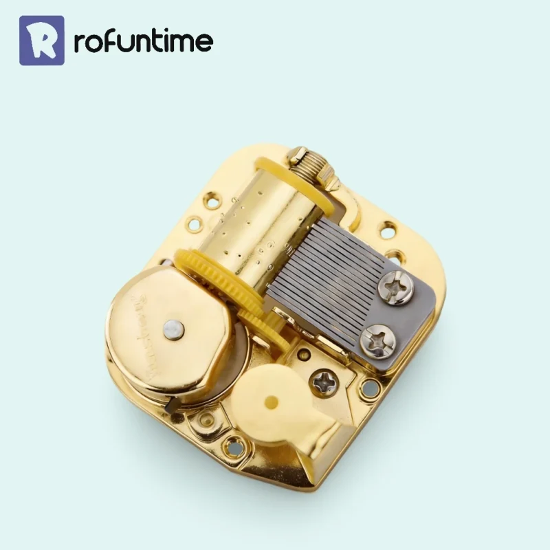Top view of a gold plated Yunsheng music box mechanism with 18 note comb.