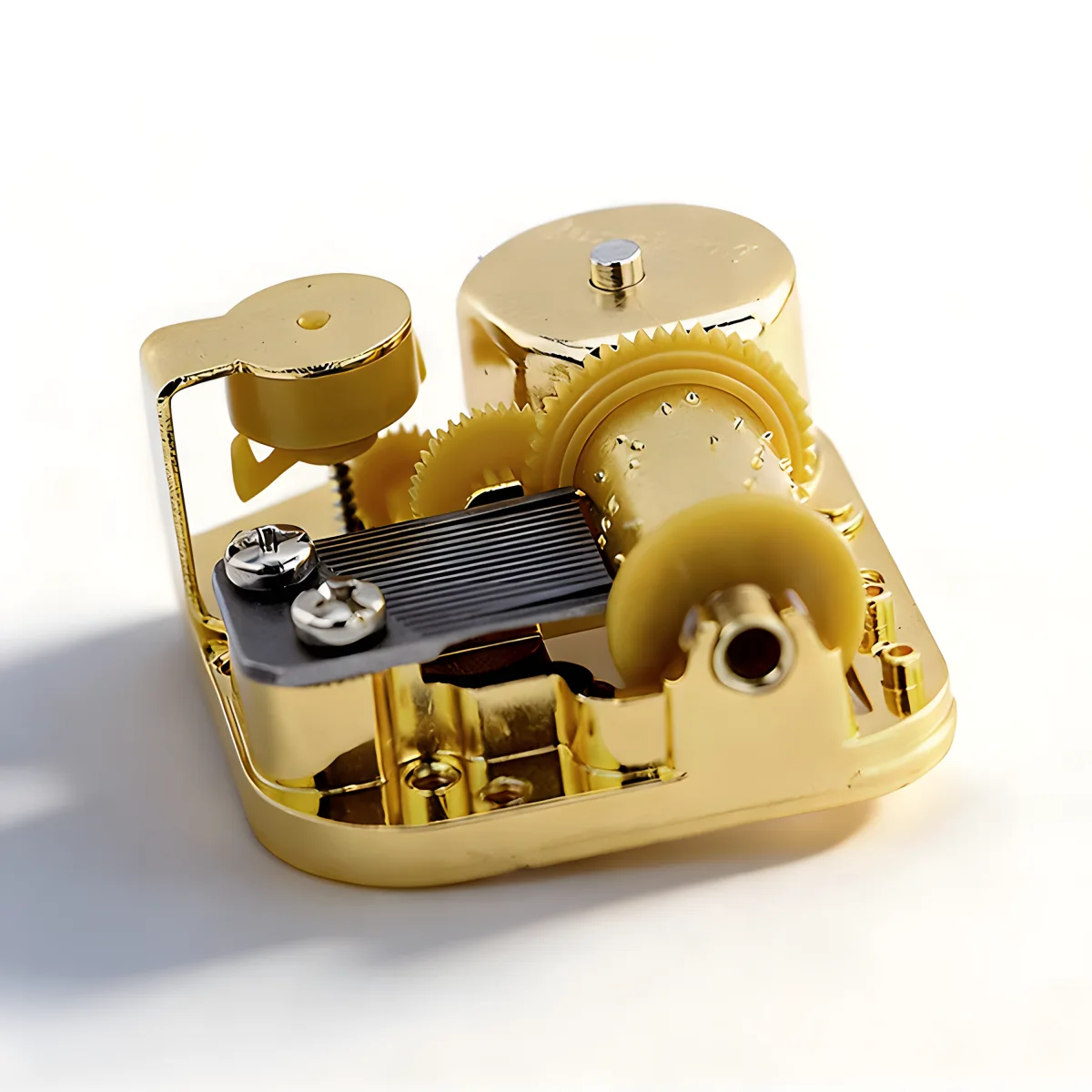 Profile view of 18 note music box mechanism highlighting the gold plated cylinder.