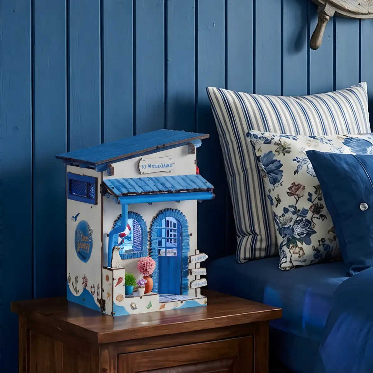 Beach themed book nook glowing as a warm bedside nightlight in a coastal bedroom.