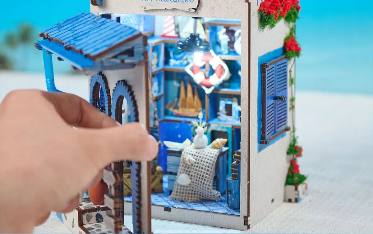 Fully opened immersive DIY book nook model displaying both facade and inner ocean shop.