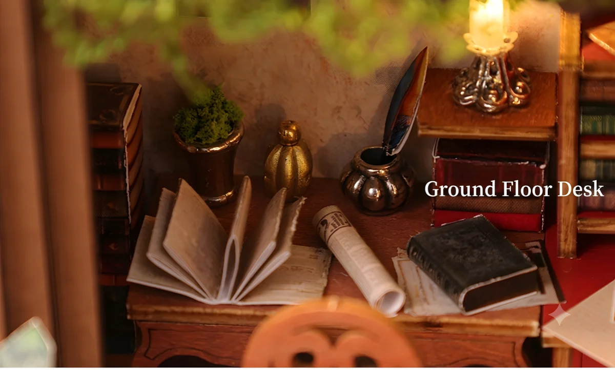 Vintage Miniature House workspace detail featuring open mini books, scroll, and candle lamp